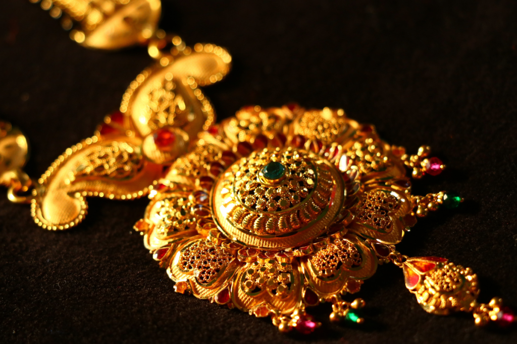 Customer comparing selling gold versus taking gold loan options with a financial advisor